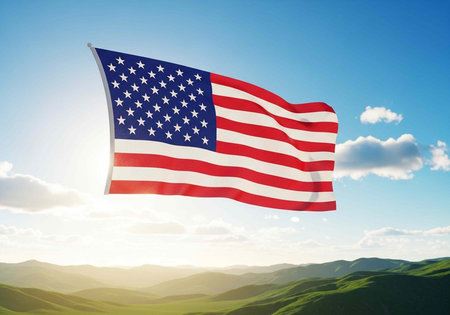 The American flag waving in the wind over a beautiful landscape of green hills and blue sky