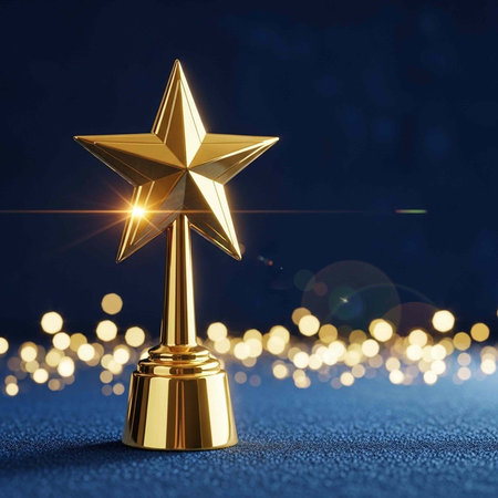 A gold star trophy stands on a blue surface with shining lights in the background at nightの写真素材