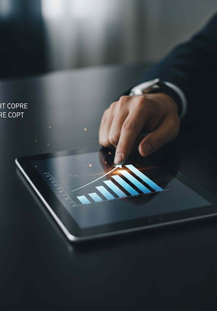 Close-up of hand in suit interacting with tablet displaying blue bar graph on screen