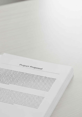 Close-up of project proposal document on white surface, with text and title visible