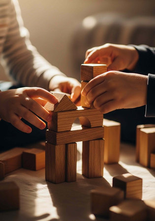 Two people building a wooden structure with blocks on a table