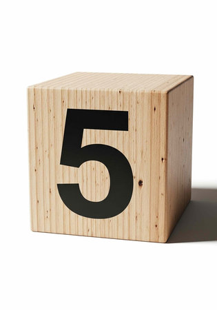 A wooden block with the number five printed on it in a clean and minimalist environmentの写真素材