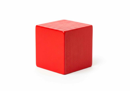 A bright red cube sitting on a plain white background with subtle shadows
