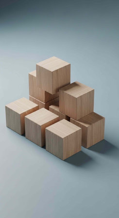 A stack of light brown wooden blocks forming a pyramid shape on a gray surface