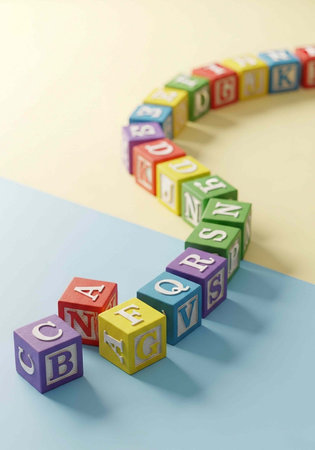 Vibrant wooden blocks with letters on a blue and beige surface, arranged in a curved line.の写真素材