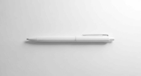 A sleek white pen lies on a clean white surface, ready for writing and creativity.