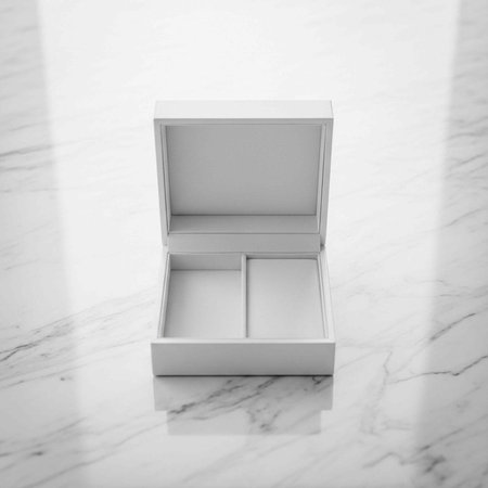 A white jewelry box with a marble background, open and empty, showcasing its interior compartments.