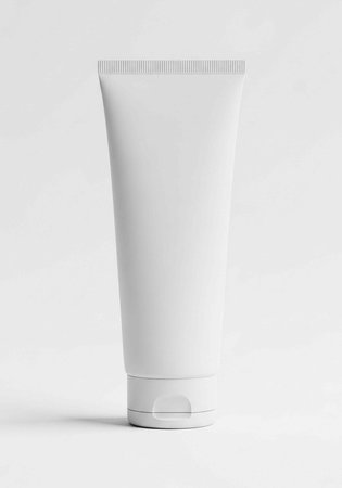 A white tube of cosmetic product on a plain background for beauty and skincare advertisingの写真素材