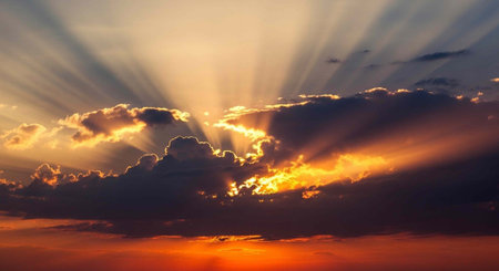 Dramatic sunset scene with sun rays shining through clouds, warm colors in the sky