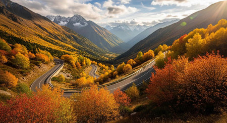 Scenic highway curves through valley surrounded by trees with yellow, orange, and red leaves, under...
