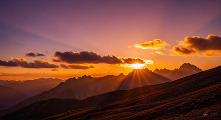 Serene mountain range at sunset with warm colors and sun rays peeking through clouds