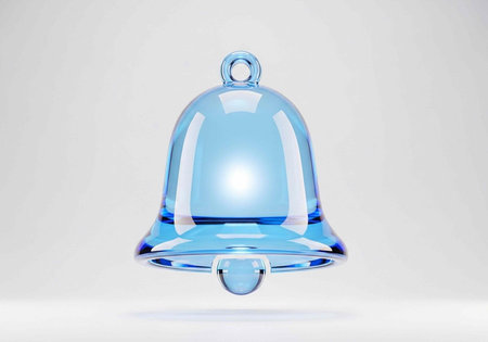 A beautiful blue glass bell with a shiny surface, a small loop at the top, and a tiny ball hanging...