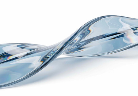 A sleek, modern glass sculpture with a wavy design on a white background, reflecting light beautifully.の写真素材