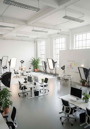 A modern office space with white desks and chairs, featuring large windows and a minimalist...