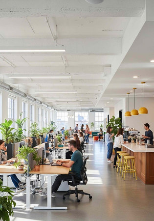 A modern office space with people working at desks and collaborating in a bright and airy environmentの写真素材
