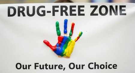 A colorful handprint on a drug-free zone sign with a bold message
