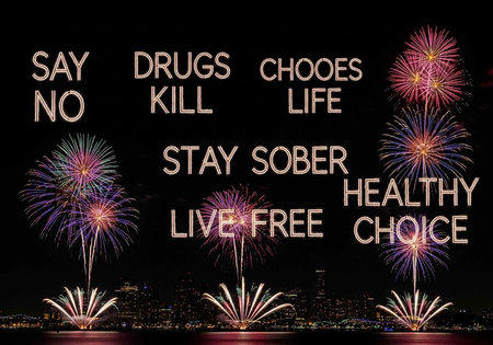 A vibrant cityscape at night with fireworks and a powerful anti-drug message displayed prominently