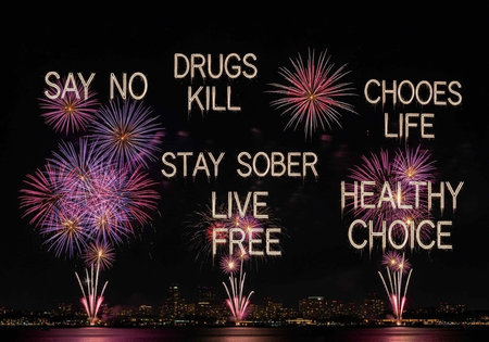 A vibrant cityscape at night with fireworks and a powerful anti-drug message displayed prominently