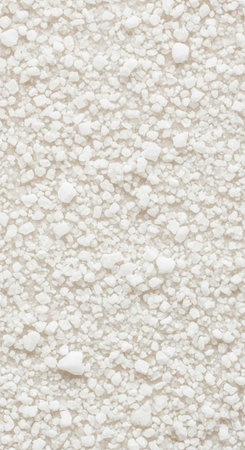 Small, white, irregular particles on beige surface, texture detail