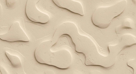 A close-up view of a textured beige surface with irregular patterns and shapes