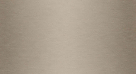 A close-up view of a textured beige surface with a subtle gradient effect