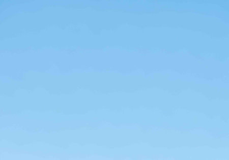 A serene blue sky with a gradient of light to dark shades