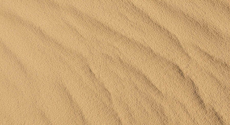 A close-up view of smooth sand with intricate wavy patterns