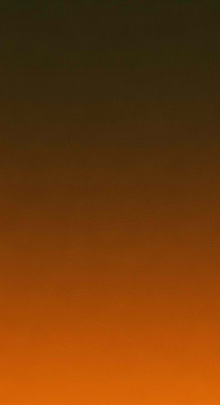 A vibrant orange and black gradient sky during a serene sunset