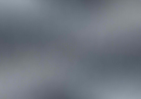 A blurry gray and white abstract background with a smooth gradient effect
