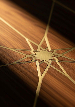 A close-up view of a wooden surface with a gold inlay design