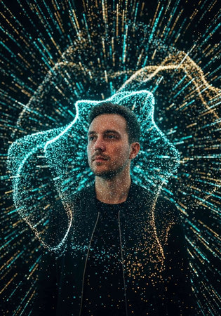 Portrait of a man with short hair and a black shirt, surrounded by vibrant blue and yellow lights