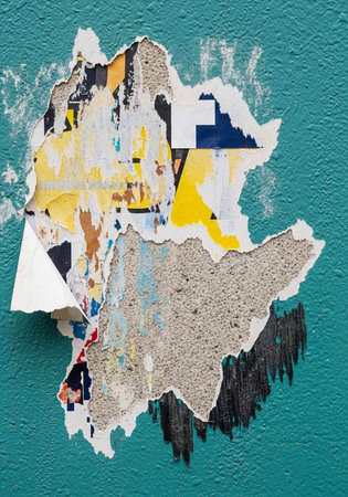A vibrant teal wall with torn and peeling colorful posters and stickers