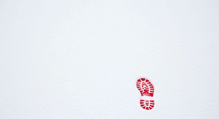 Red shoe print on the white snow background with copy space for text