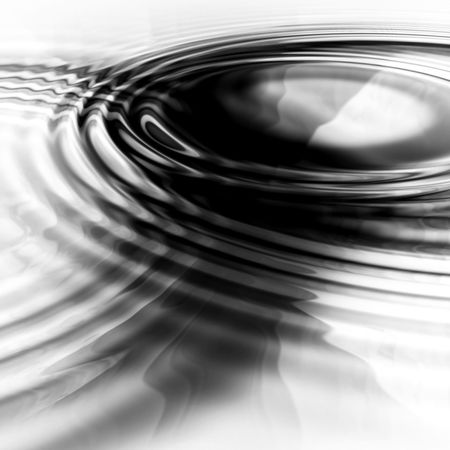 two abstract liquid ripples joining togetherの写真素材