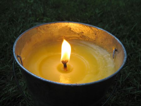 A yellow citronella bucket candle - perfect for those summertime evenings to keep the mosquitos away.の写真素材