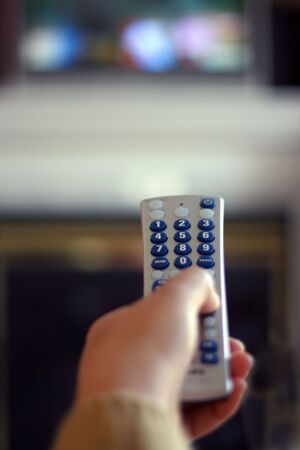 A remote control in action - shallow depth of field, with focus on the remote.の写真素材