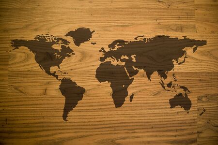 A map of the world and all of the continents over a woodgrain texture.の写真素材