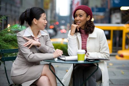 Two business women having a casual meeting or discussion in the city. の写真素材