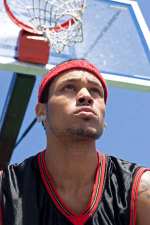 A young basketball player gripping the ball tightly.