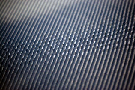 A closeup of real carbon fiber material.  This makes an excellent texture or background.  Shallow depth of field.の写真素材