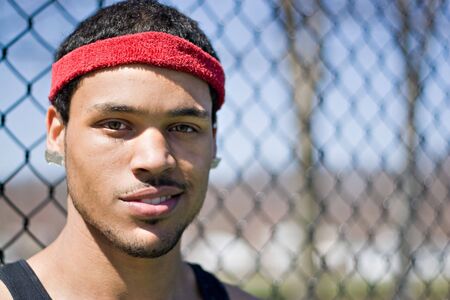 A portrait of a young basketball player at the basketball court in the park.の写真素材