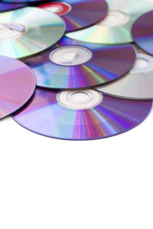 Blank dvd disks scatted over a white background.  Shallow depth of field.