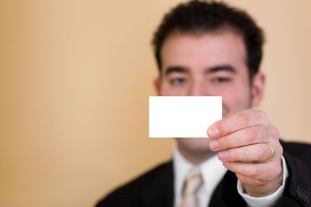 Close up of a man holding a business card up.  Plenty of copyspace for your logo or design.  Shallow depth of field.の写真素材