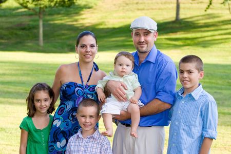 Portrait of an attractive young family with four children.