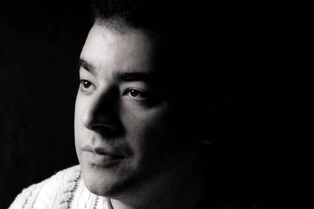 Portrait of a serious young man in dramatic lighting.