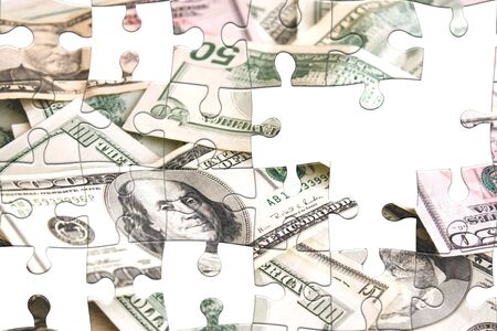 Photo montage with puzzle pieces and scattered money.の写真素材
