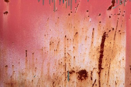 A rotted and rusted metal panel covered in rust.