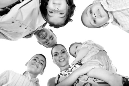 A happy family posing in a group huddle formation with a unique perspective.の写真素材