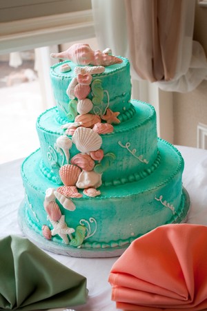 A blue beach themed wedding cake with three tiers.の写真素材