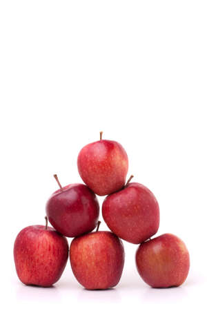 A pyramid of red delicious apples on a white background.の写真素材